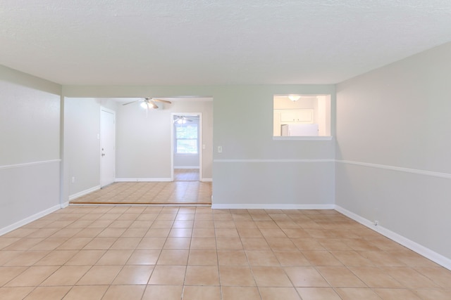 6609 Imogene St, Houston, TX 77074 - empty room with ceiling fan, light tile patterned flooring, and a textured ceiling