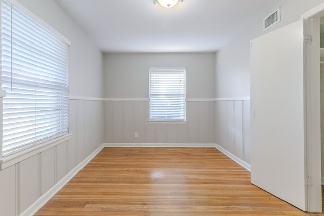 6609 Imogene St, Houston, TX 77074 - empty room featuring light wood-style flooring and wainscoting