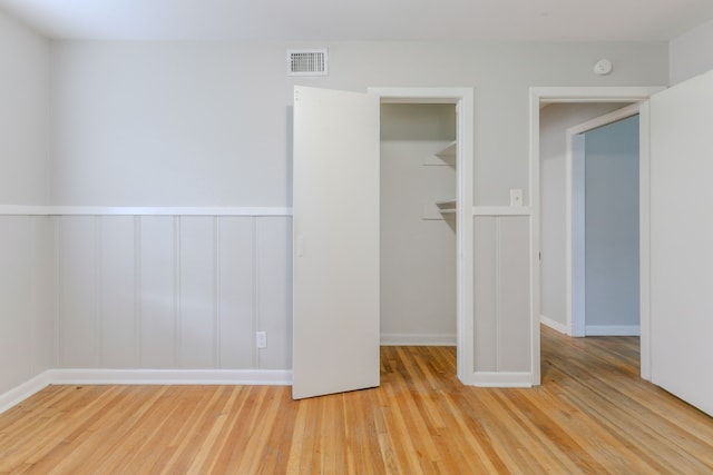 6609 Imogene St, Houston, TX 77074 - unfurnished bedroom with light wood-style floors and a walk in closet