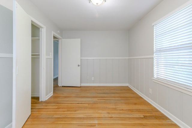 6609 Imogene St, Houston, TX 77074 - unfurnished bedroom with light wood-style flooring and a wainscoted wall