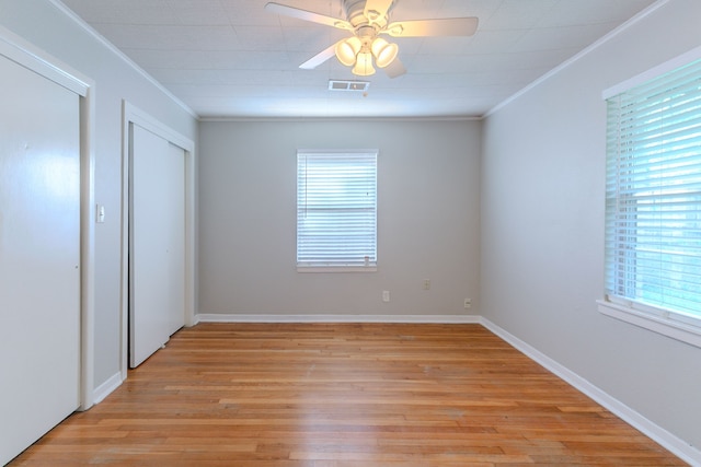 6609 Imogene St, Houston, TX 77074 - unfurnished bedroom featuring ornamental molding, light wood-type flooring, and ceiling fan