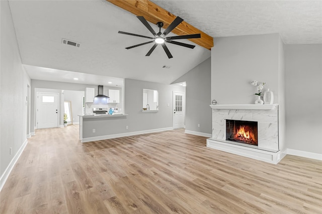 10503 Long River Dr, Sugar Land, TX 77498 - unfurnished living room with light wood-style floors, a high end fireplace, a ceiling fan, and recessed lighting