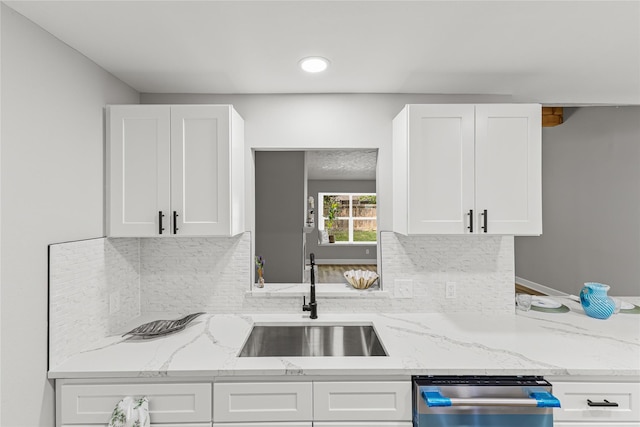 10503 Long River Dr, Sugar Land, TX 77498 - kitchen with white cabinets, dishwasher, light stone counters, and recessed lighting