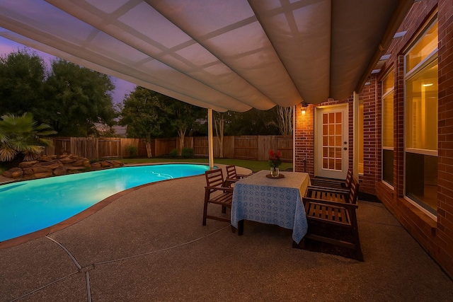 1922 Briarchester Dr, Katy, TX 77450 - pool at dusk featuring a patio and a fenced backyard