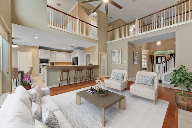 1922 Briarchester Dr, Katy, TX 77450 - living area with light wood-type flooring, a high ceiling, a ceiling fan, stairway, and recessed lighting