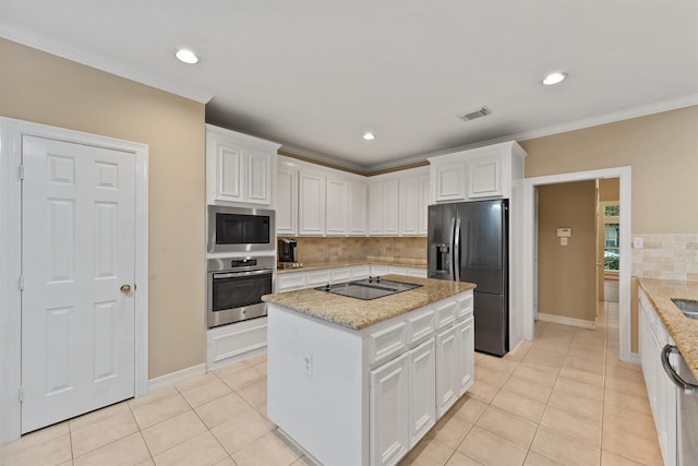 1922 Briarchester Dr, Katy, TX 77450 - kitchen featuring appliances with stainless steel finishes, white cabinetry, backsplash, light tile patterned floors, and crown molding