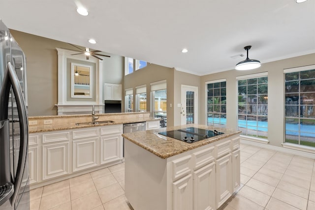1922 Briarchester Dr, Katy, TX 77450 - kitchen featuring stainless steel appliances, a kitchen island, light tile patterned floors, white cabinets, and recessed lighting