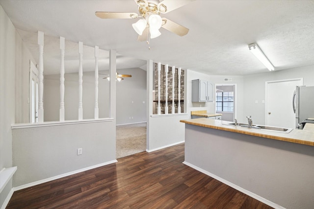 2850 Pheasant Run, Humble, TX 77396 - kitchen featuring freestanding refrigerator, a ceiling fan, dark wood finished floors, light countertops, and a peninsula