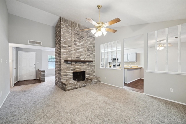 2850 Pheasant Run, Humble, TX 77396 - unfurnished living room with high vaulted ceiling, a ceiling fan, carpet, and a fireplace