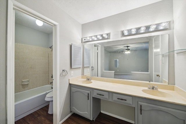 2850 Pheasant Run, Humble, TX 77396 - full bathroom featuring wood finished floors, double vanity, ceiling fan, and shower / bath combination