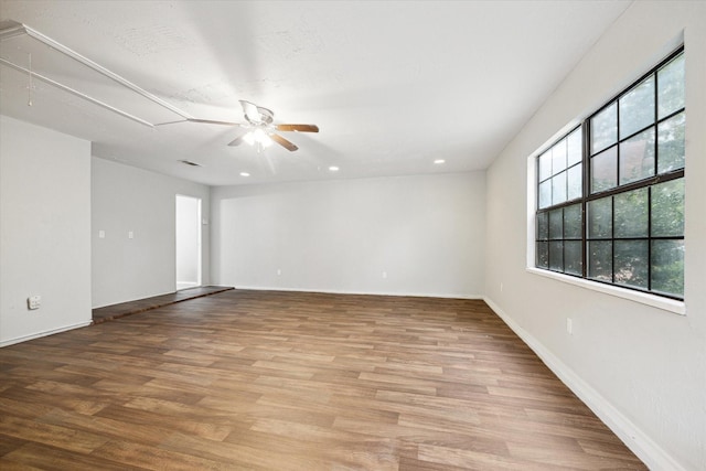 2850 Pheasant Run, Humble, TX 77396 - empty room featuring attic access, ceiling fan, wood finished floors, and recessed lighting