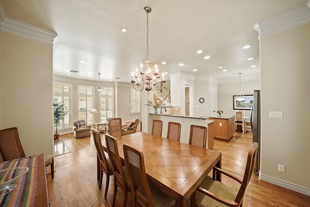 4009 Bellefontaine St, Houston, TX 77025 - dining area with ornamental molding, recessed lighting, light wood finished floors, and a chandelier