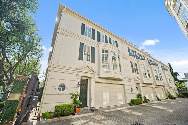 4009 Bellefontaine St, Houston, TX 77025 - view of building exterior featuring an attached garage and driveway