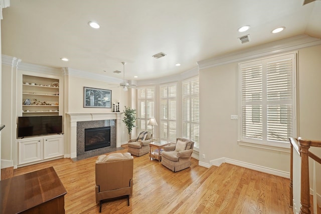 4009 Bellefontaine St, Houston, TX 77025 - living room featuring healthy amount of natural light, a fireplace, ornamental molding, recessed lighting, and light wood finished floors