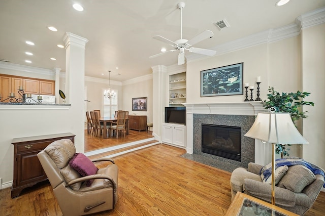 4009 Bellefontaine St, Houston, TX 77025 - living room with wood finished floors, recessed lighting, a high end fireplace, crown molding, and ceiling fan