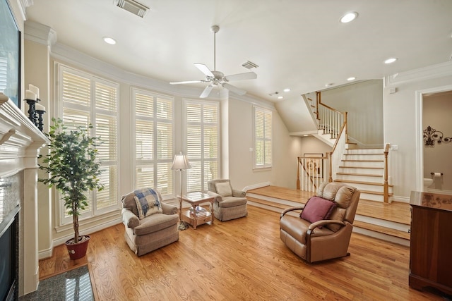 4009 Bellefontaine St, Houston, TX 77025 - living area featuring a fireplace, ornamental molding, stairway, wood finished floors, and recessed lighting