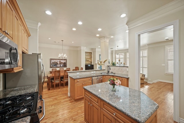 4009 Bellefontaine St, Houston, TX 77025 - kitchen featuring stainless steel appliances, a kitchen island, light wood-style flooring, light stone counters, and recessed lighting