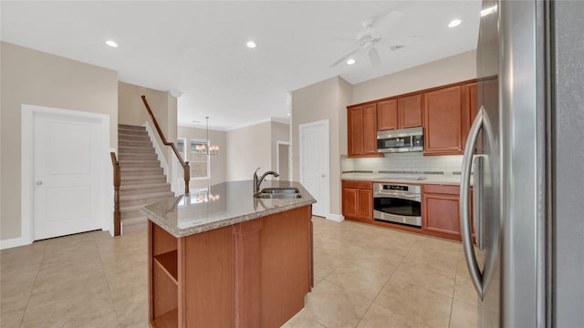 12610 Baldwin Springs Ct, Tomball, TX 77377 - kitchen with appliances with stainless steel finishes, tasteful backsplash, light tile patterned flooring, a center island with sink, and recessed lighting