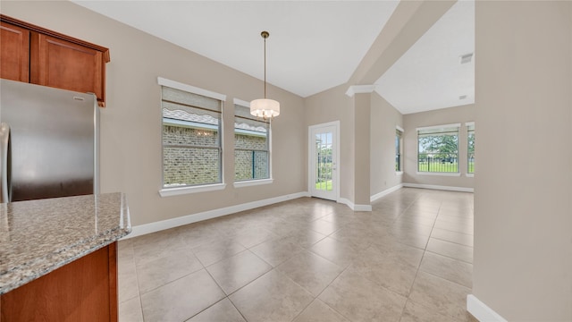 12610 Baldwin Springs Ct, Tomball, TX 77377 - unfurnished dining area with a chandelier, lofted ceiling, and light tile patterned floors