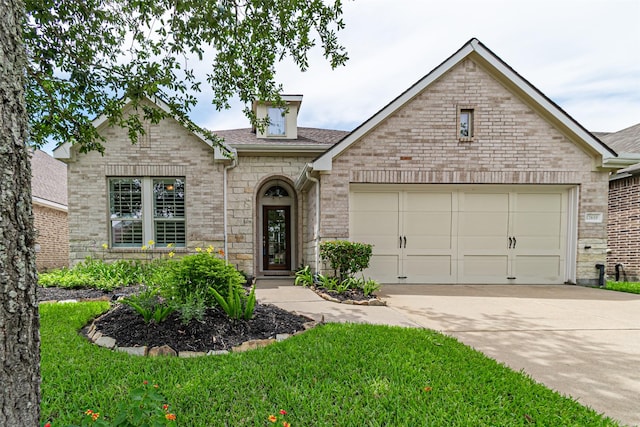 12610 Baldwin Springs Ct, Tomball, TX 77377 - view of front of house with concrete driveway, an attached garage, roof with shingles, brick siding, and stone siding