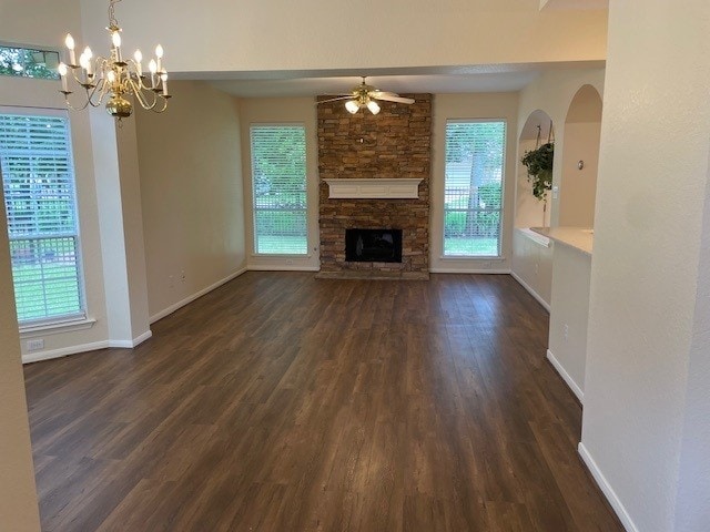2111 Ridge Wood Ln, Sugar Land, TX 77479 - unfurnished living room with dark wood finished floors, a ceiling fan, healthy amount of natural light, and a fireplace