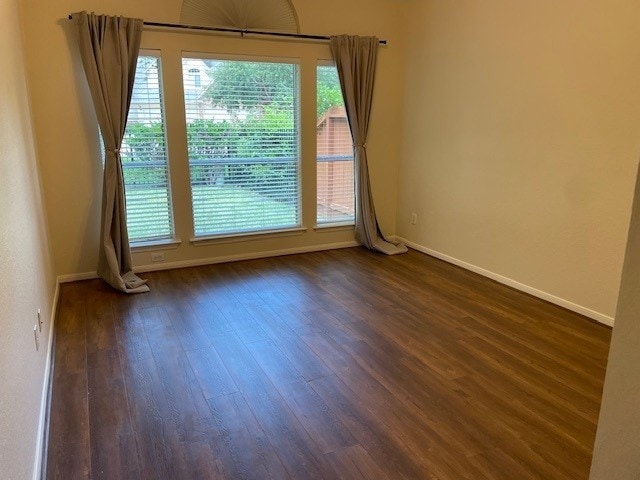 2111 Ridge Wood Ln, Sugar Land, TX 77479 - spare room featuring dark wood-style floors and baseboards