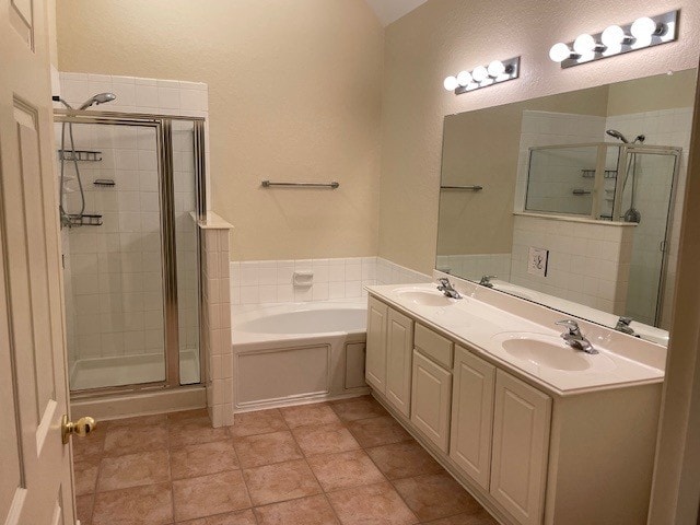 2111 Ridge Wood Ln, Sugar Land, TX 77479 - bathroom with a stall shower, a garden tub, double vanity, and a textured wall