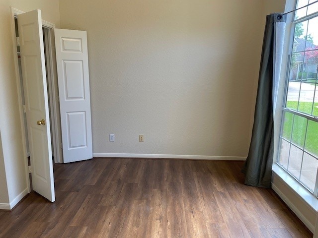 2111 Ridge Wood Ln, Sugar Land, TX 77479 - spare room with wood finished floors and plenty of natural light