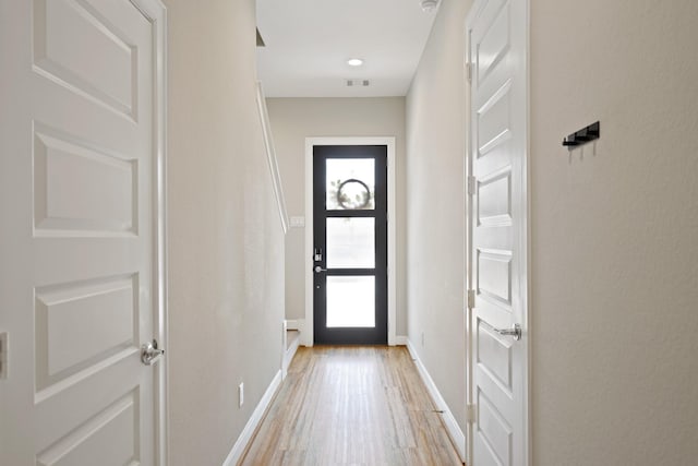 911 W 35th St Unit C, Houston, TX 77018 - doorway featuring light wood-style floors and baseboards