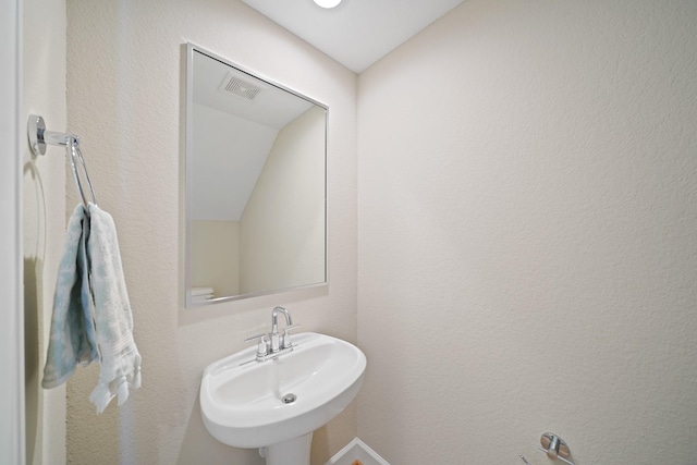 911 W 35th St Unit C, Houston, TX 77018 - bathroom with a sink and vaulted ceiling