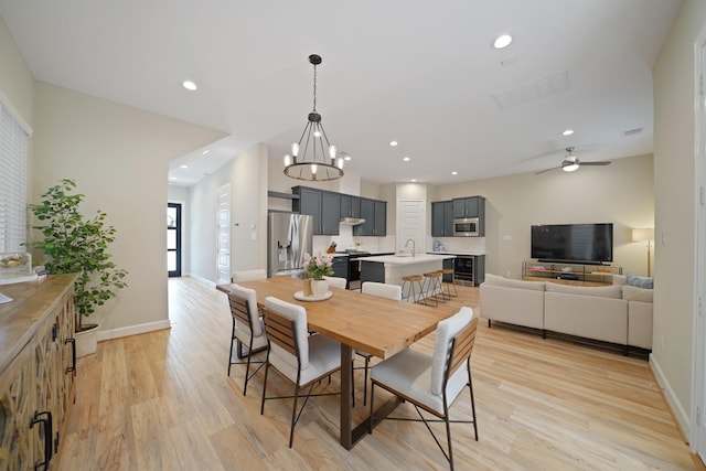 911 W 35th St Unit C, Houston, TX 77018 - dining space featuring light wood-type flooring, ceiling fan, wine cooler, recessed lighting, and a chandelier