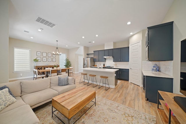 911 W 35th St Unit C, Houston, TX 77018 - living room with a chandelier, light wood finished floors, and recessed lighting