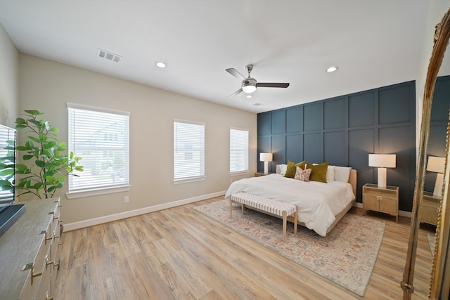 911 W 35th St Unit C, Houston, TX 77018 - bedroom featuring multiple windows, light wood-style flooring, recessed lighting, a decorative wall, and a ceiling fan