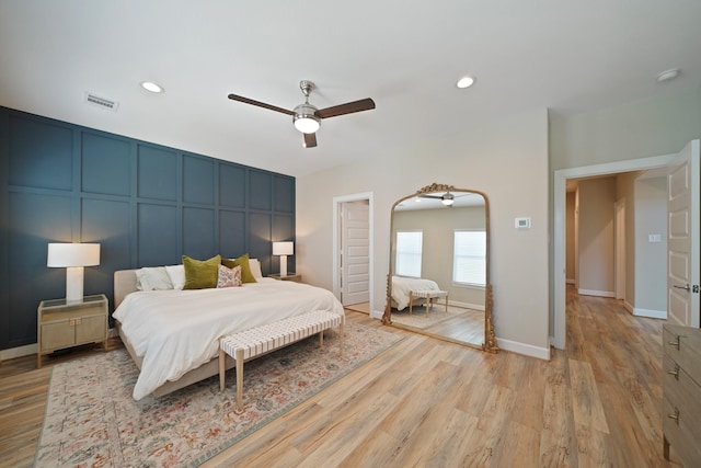 911 W 35th St Unit C, Houston, TX 77018 - bedroom with light wood-type flooring, a decorative wall, ceiling fan, recessed lighting, and arched walkways