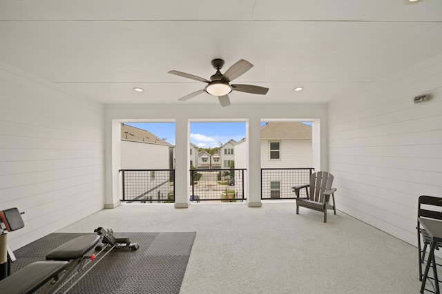 911 W 35th St Unit C, Houston, TX 77018 - exercise room with carpet floors, wooden walls, a ceiling fan, recessed lighting, and a residential view