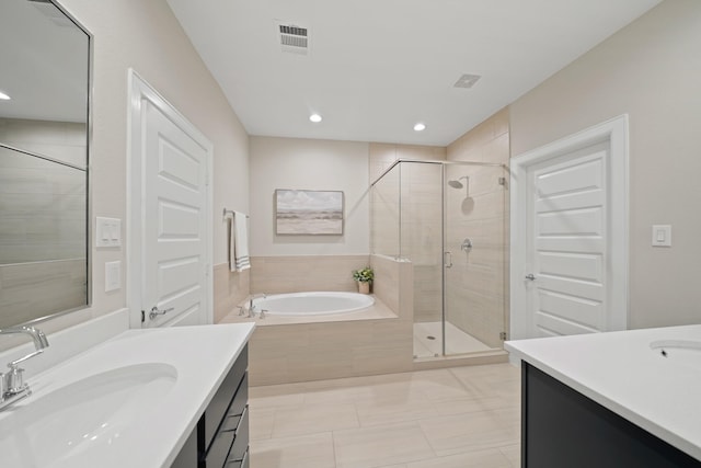 911 W 35th St Unit C, Houston, TX 77018 - full bathroom featuring two vanities, a bath, a stall shower, recessed lighting, and tile patterned floors