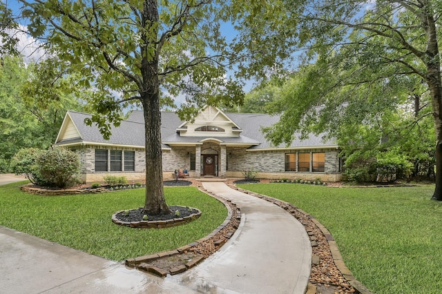 11304 Monarchs Way, Montgomery, TX 77316 - view of front of home featuring a front lawn, roof with shingles, stone siding, and brick siding