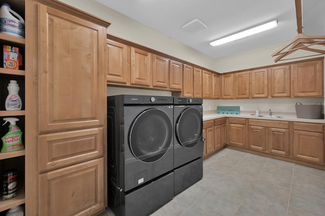 11304 Monarchs Way, Montgomery, TX 77316 - washroom with washer and clothes dryer, cabinet space, and light tile patterned flooring