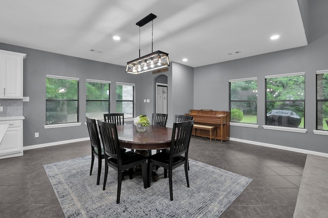 11304 Monarchs Way, Montgomery, TX 77316 - dining space with arched walkways, dark tile patterned flooring, and recessed lighting