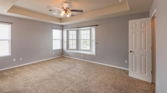 14911 Calico Heights Ln, Cypress, TX 77429 - empty room featuring a tray ceiling, carpet flooring, and ceiling fan