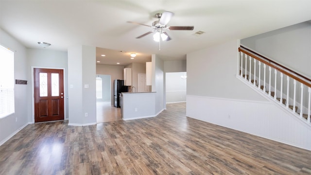 14911 Calico Heights Ln, Cypress, TX 77429 - unfurnished living room with wood finished floors, a ceiling fan, and stairs