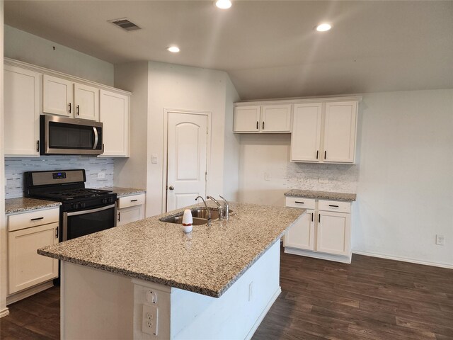 20390 Tembec Dr, New Caney, TX 77357 - kitchen featuring stainless steel appliances, white cabinetry, light stone countertops, and recessed lighting