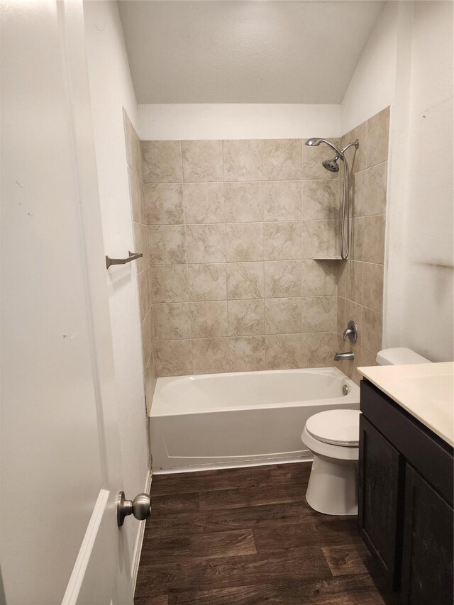 20390 Tembec Dr, New Caney, TX 77357 - full bath featuring vanity, wood finished floors, shower / bathtub combination, and vaulted ceiling