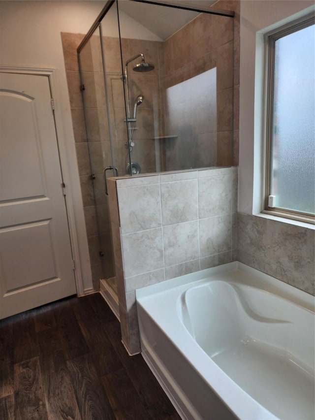 20390 Tembec Dr, New Caney, TX 77357 - bathroom featuring a stall shower, a garden tub, and wood finished floors