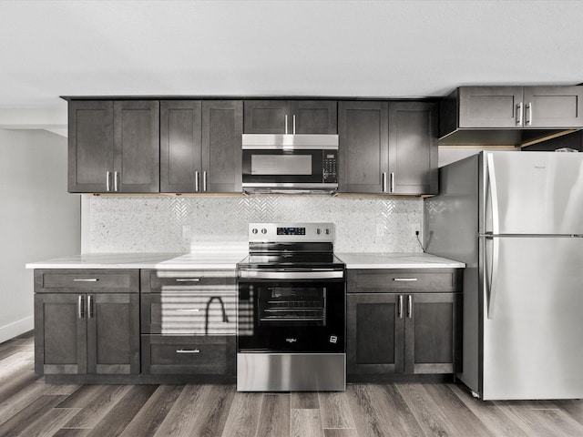 246 18th St, Dickinson, TX 77539 - kitchen with stainless steel appliances, light countertops, dark wood-style floors, and tasteful backsplash