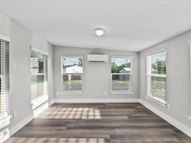 246 18th St, Dickinson, TX 77539 - unfurnished dining area featuring a wall mounted air conditioner, plenty of natural light, and dark wood finished floors