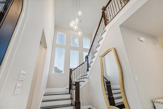3954 Kelley Pond Dr, Spring, TX 77386 - staircase with a high ceiling and baseboards
