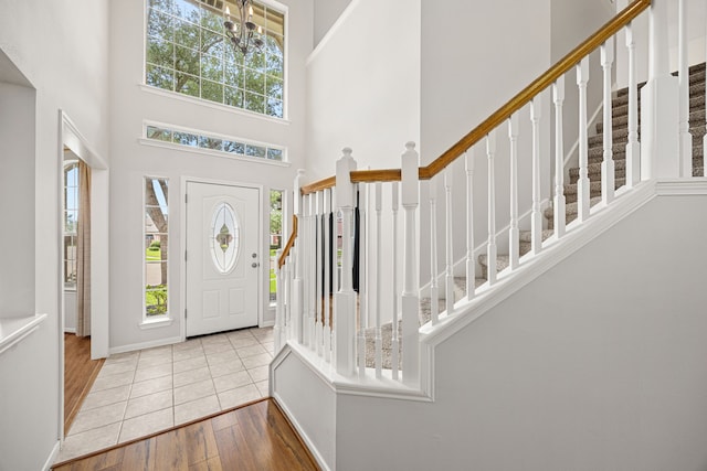 2722 Round Hill Ct, Katy, TX 77494 - foyer entrance featuring stairway, a high ceiling, hardwood / wood-style flooring, and a chandelier