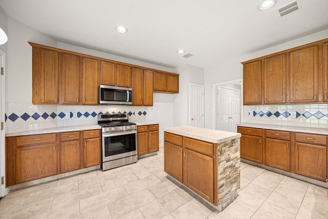 2722 Round Hill Ct, Katy, TX 77494 - kitchen featuring stainless steel appliances, brown cabinets, light countertops, decorative backsplash, and recessed lighting