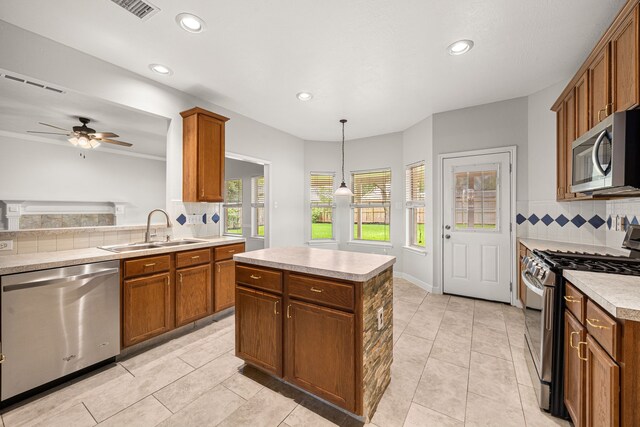 2722 Round Hill Ct, Katy, TX 77494 - kitchen featuring appliances with stainless steel finishes, decorative backsplash, light tile patterned floors, recessed lighting, and brown cabinetry
